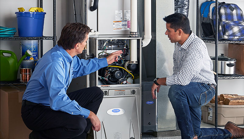 HVAC technician evaluating a furnace for repair or replacement in West Valley City