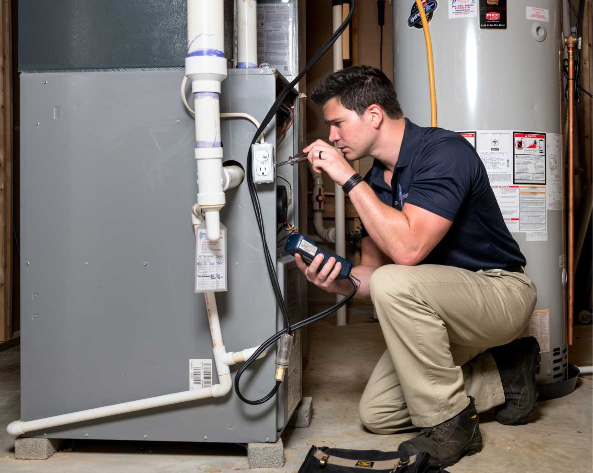 HVAC technician performing a furnace tune-up in West Valley City