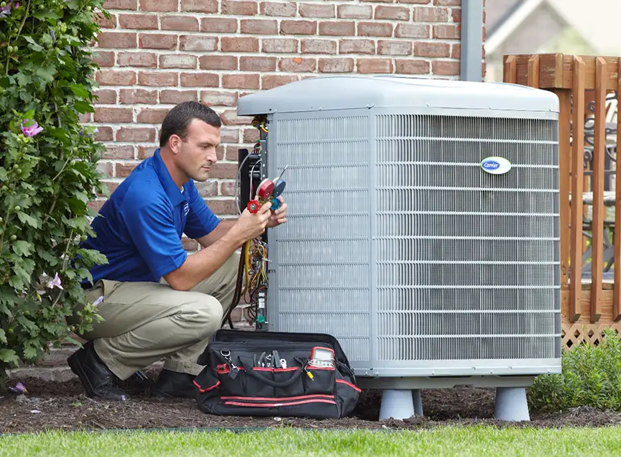HVAC technician inspecting an outdoor air conditioning unit in West Valley City