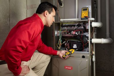 furnace repair Heating and air conditioning technician servicing an indoor furnace in West Valley City, UT